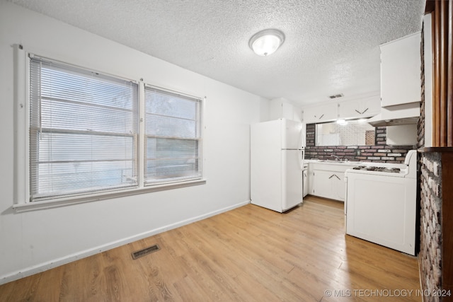 kitchen featuring white cabinetry, light wood-type flooring, exhaust hood, sink, and white appliances