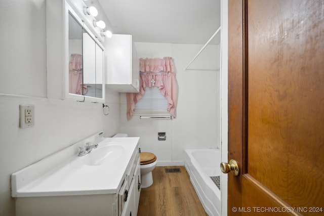 full bathroom featuring tub / shower combination, wood-type flooring, vanity, and toilet