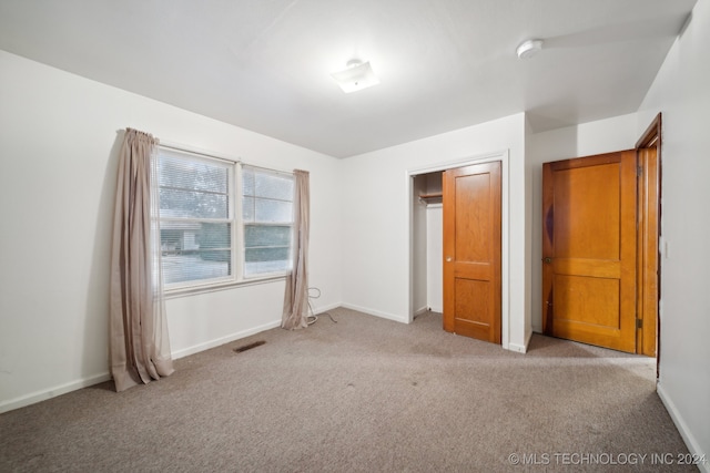 unfurnished bedroom featuring light colored carpet