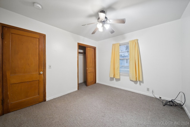 unfurnished bedroom featuring carpet, ceiling fan, and a closet