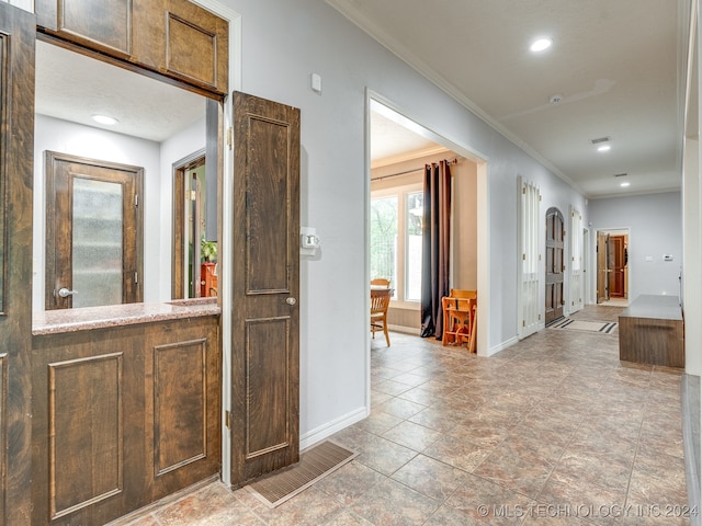 corridor featuring ornamental molding