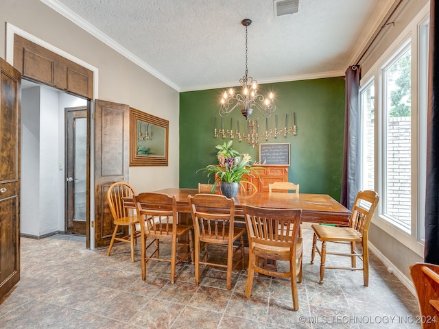 dining room with ornamental molding, a textured ceiling, a chandelier, and a wealth of natural light