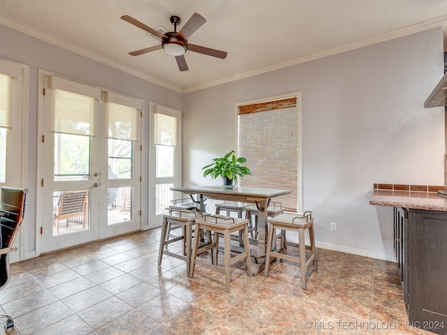 dining space with ceiling fan, french doors, and crown molding