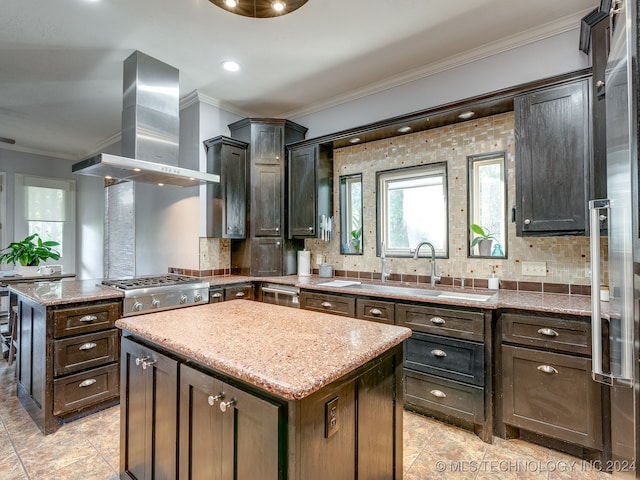 kitchen featuring decorative backsplash, island range hood, a kitchen island, and light stone counters