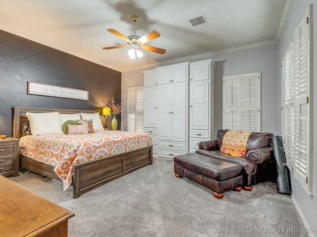 carpeted bedroom with ceiling fan, a textured ceiling, and crown molding