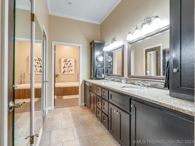 bathroom with vanity, a bathing tub, crown molding, and tile patterned floors