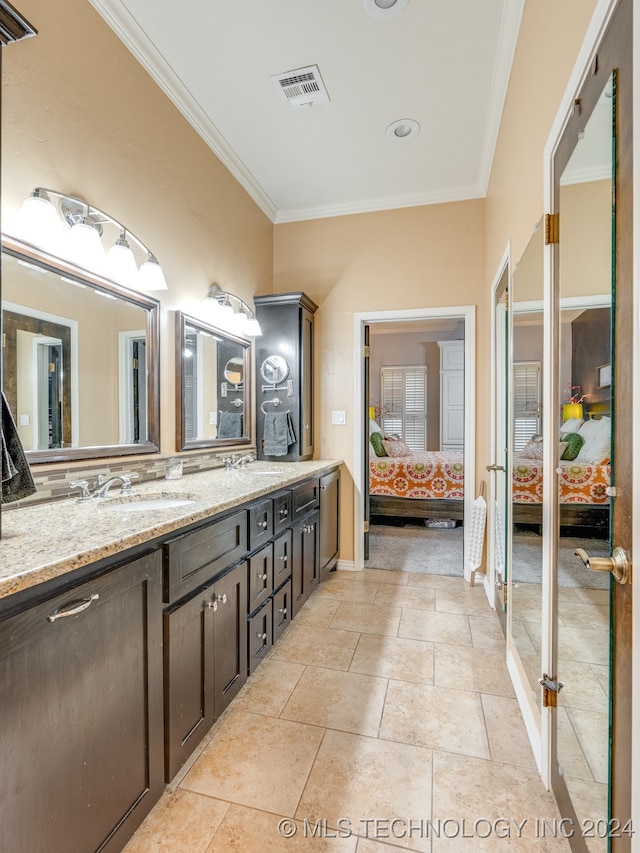 bathroom featuring ornamental molding and vanity