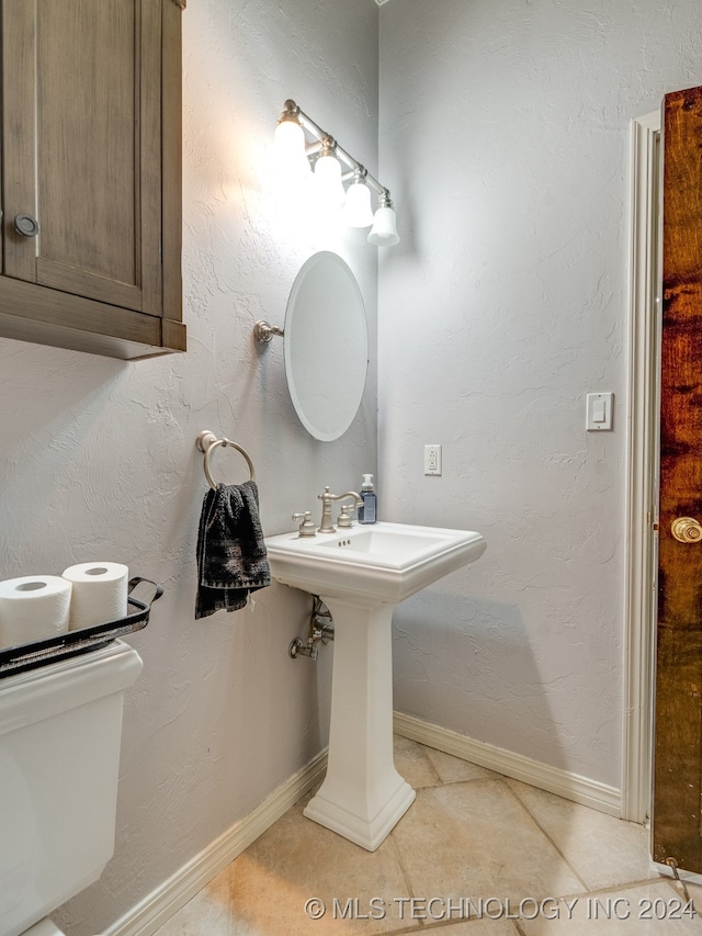 bathroom featuring toilet and tile patterned floors