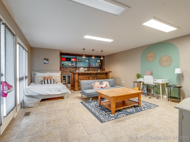 bedroom with beverage cooler and indoor bar