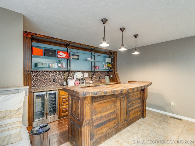 bar with butcher block countertops, wine cooler, hanging light fixtures, and decorative backsplash