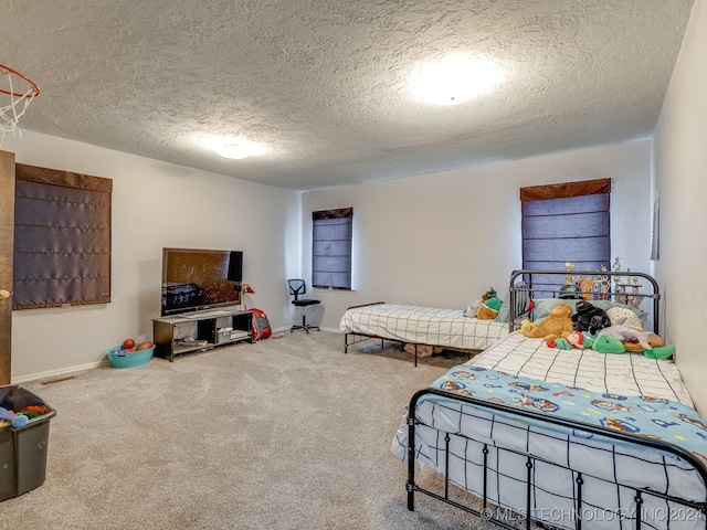 bedroom featuring carpet and a textured ceiling