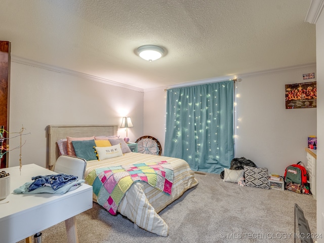 carpeted bedroom with ornamental molding and a textured ceiling