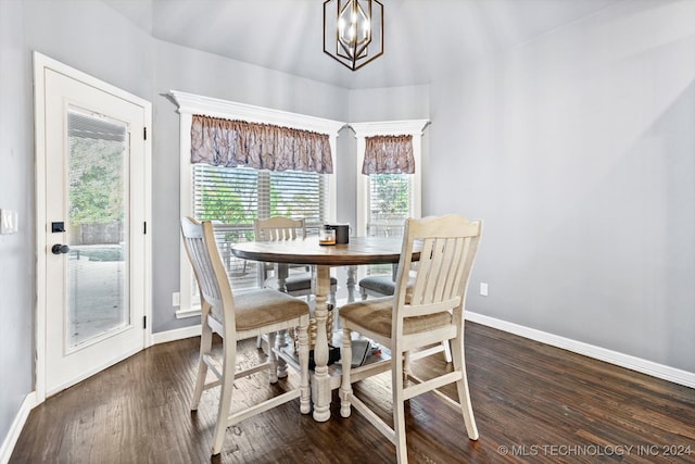 dining area with dark hardwood / wood-style flooring and a notable chandelier