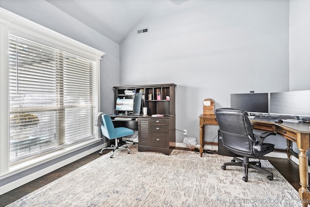 office with dark hardwood / wood-style flooring, vaulted ceiling, and a healthy amount of sunlight