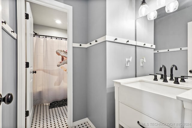 bathroom featuring vanity and curtained shower