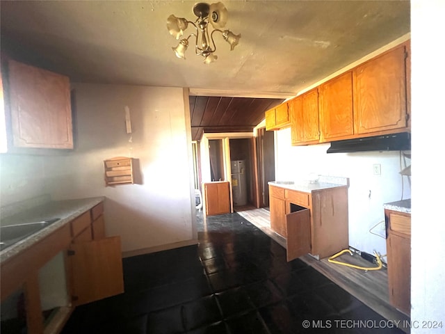 kitchen with water heater and a chandelier