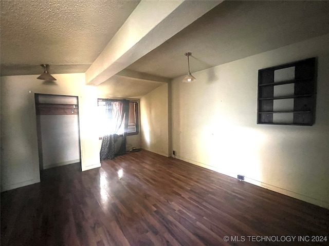 interior space featuring a textured ceiling and dark hardwood / wood-style flooring