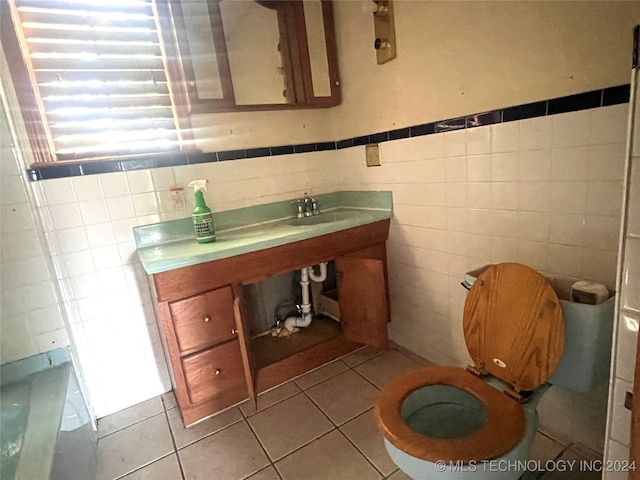 bathroom featuring sink, tile walls, toilet, and tile patterned floors