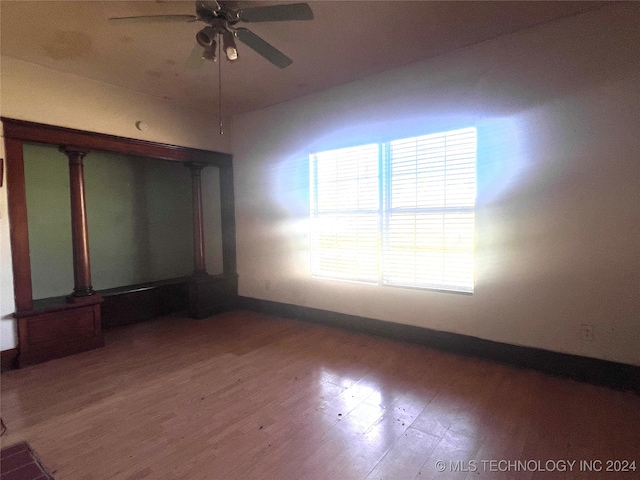 unfurnished room featuring ceiling fan and hardwood / wood-style flooring