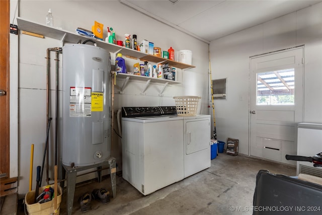 washroom with water heater and washing machine and dryer