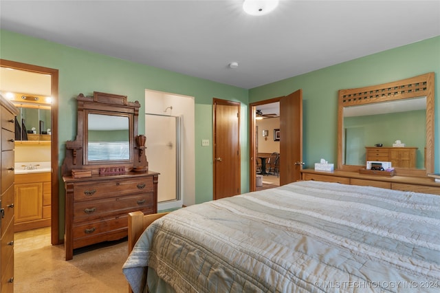 carpeted bedroom with ensuite bathroom and sink