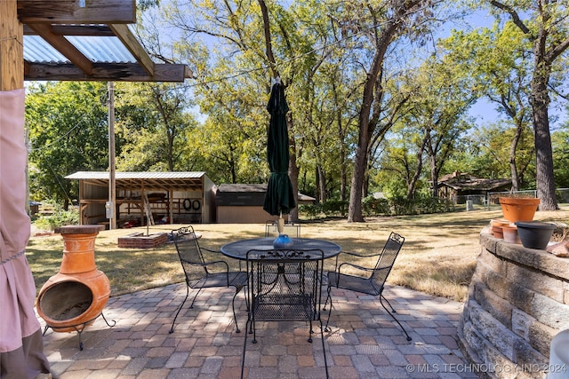 view of patio with an outbuilding