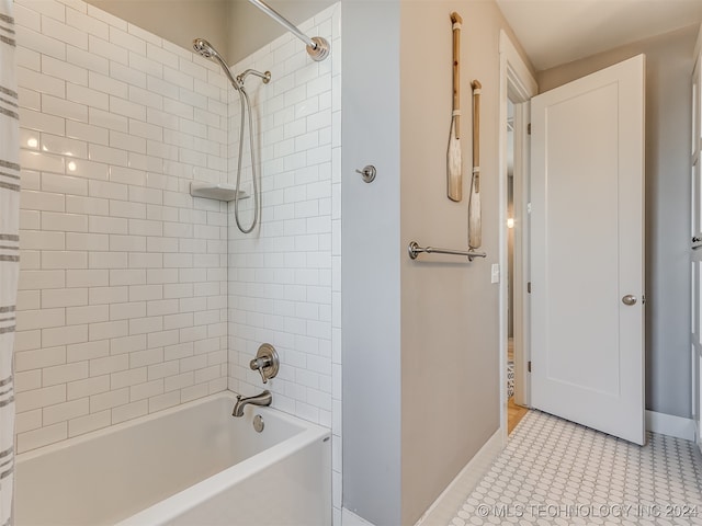 bathroom with tiled shower / bath and tile patterned flooring