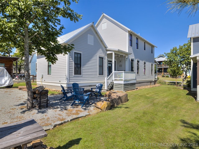 back of property featuring a yard and a patio area