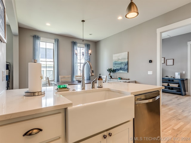 kitchen featuring hanging light fixtures, sink, a chandelier, dishwasher, and light hardwood / wood-style floors