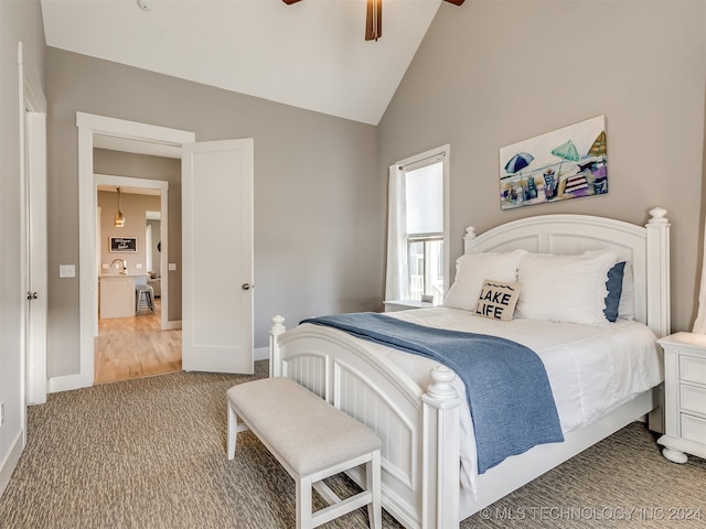 bedroom featuring ceiling fan, vaulted ceiling, and wood-type flooring