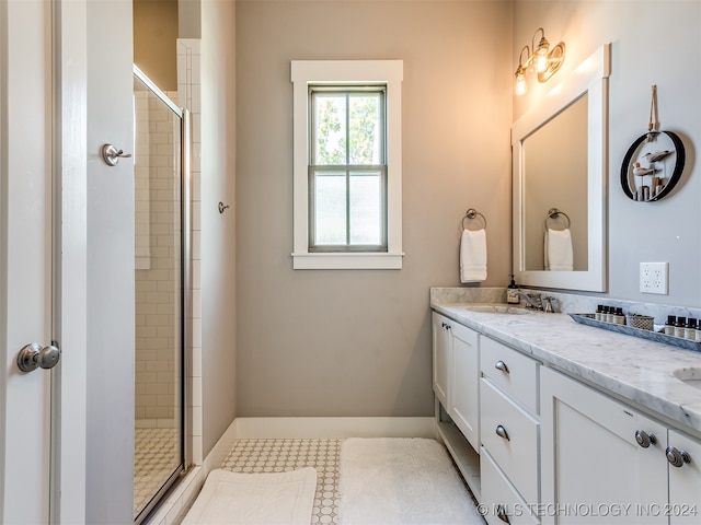 bathroom featuring an enclosed shower and vanity