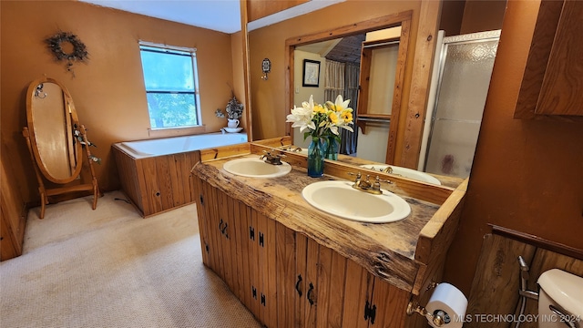 bathroom featuring vanity, a shower with shower door, and toilet