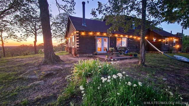 back house at dusk with french doors