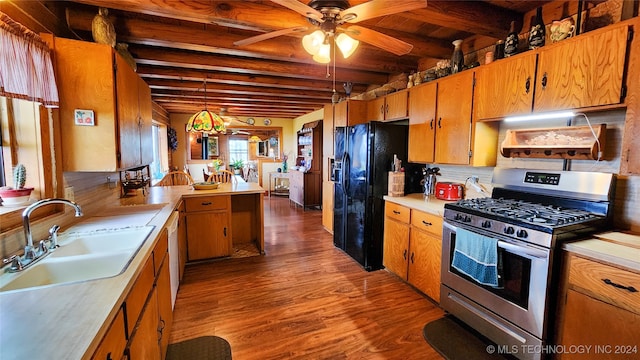 kitchen with ceiling fan, beamed ceiling, stainless steel gas range, and sink