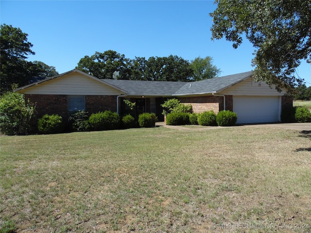 ranch-style home with a garage and a front lawn