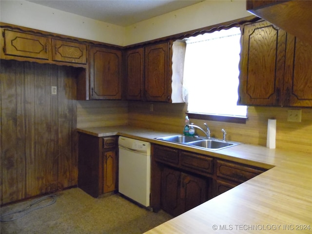 kitchen featuring dishwasher, tasteful backsplash, and sink