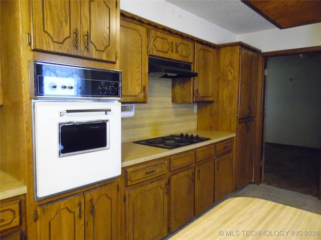 kitchen with white oven, light hardwood / wood-style floors, and gas stovetop