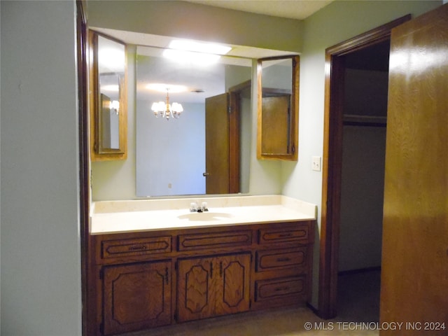 bathroom with an inviting chandelier and vanity