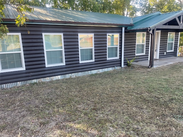 view of home's exterior featuring a yard and a patio area