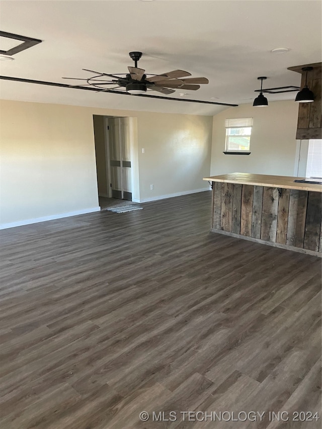 spare room with ceiling fan and dark hardwood / wood-style floors