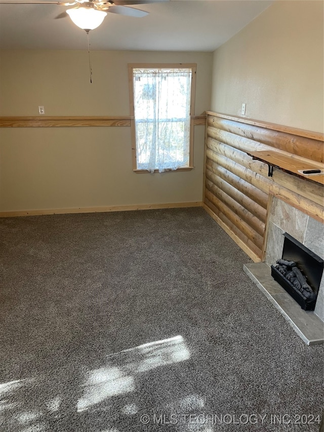 unfurnished living room with a fireplace, carpet floors, and ceiling fan