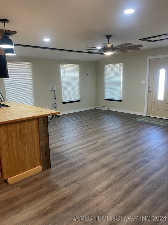 unfurnished living room with dark hardwood / wood-style floors and ceiling fan