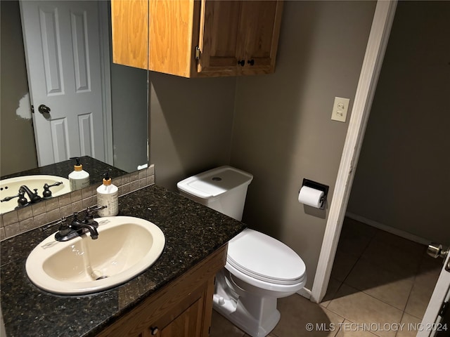 bathroom featuring vanity, toilet, and tile patterned floors