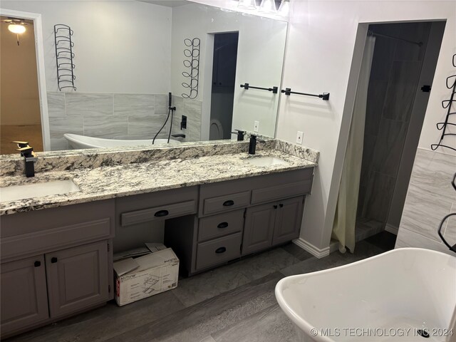 bathroom with plus walk in shower, tile walls, ceiling fan, and vanity