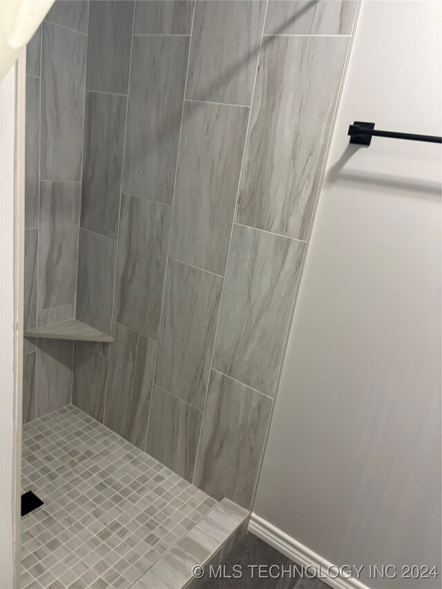 bathroom with tiled shower