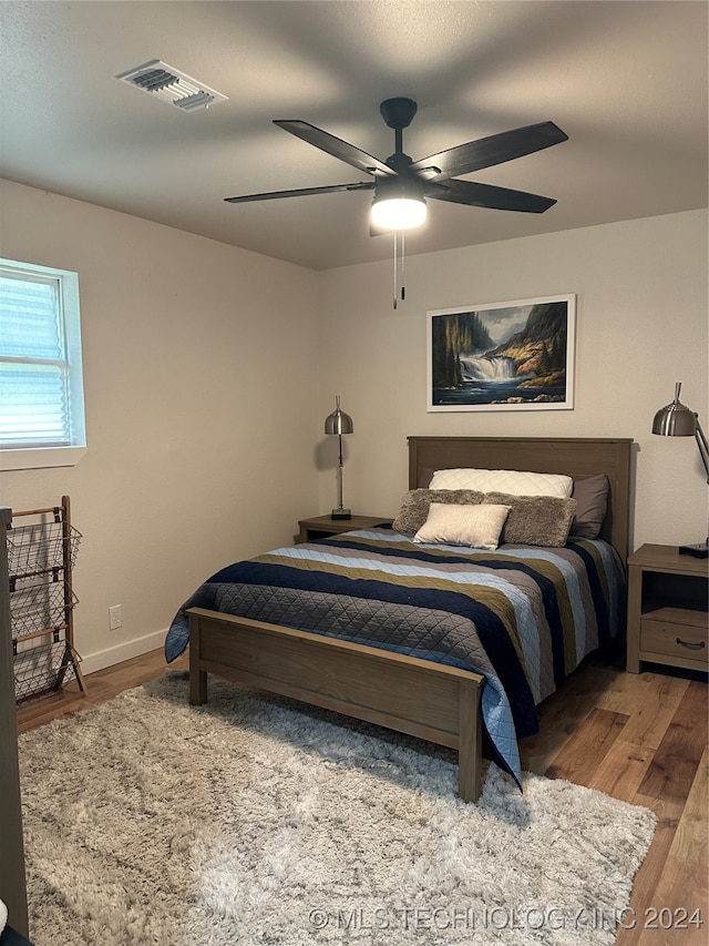 bedroom with hardwood / wood-style flooring and ceiling fan