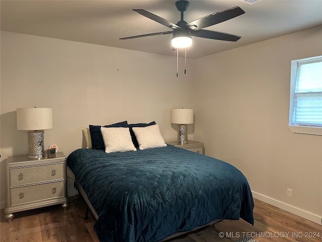 bedroom with ceiling fan and dark hardwood / wood-style floors