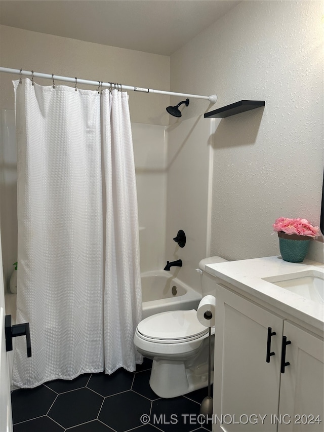 full bathroom with tile patterned floors, toilet, shower / tub combo with curtain, and vanity