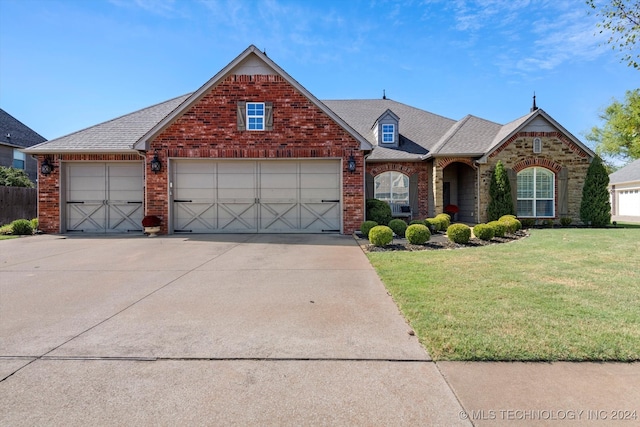 view of front of home featuring a front lawn and a garage