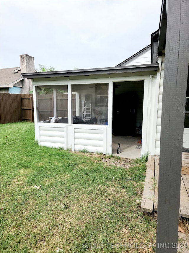 exterior space featuring a lawn and a sunroom